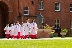 students in white and red robes